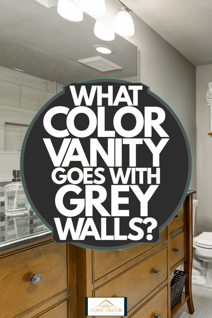 Contemporary interior of a bathroom with light gray colored walls, glass shower wall, and wooden cabinetry and a huge mirror on the vanity, What Color Vanity Goes With Grey Walls?