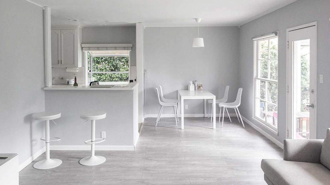 White and gray kitchen interior with dining table