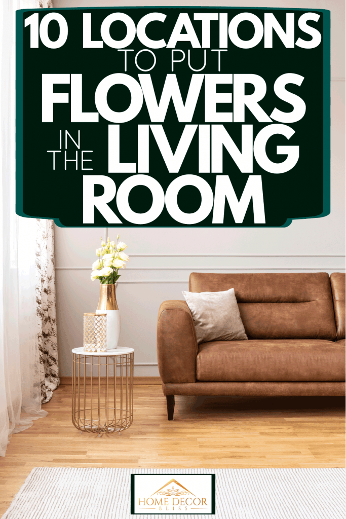 A brown leather sofa with a small accent table on the side decorated with flowers, 10 Locations To Put Flowers In The Living Room