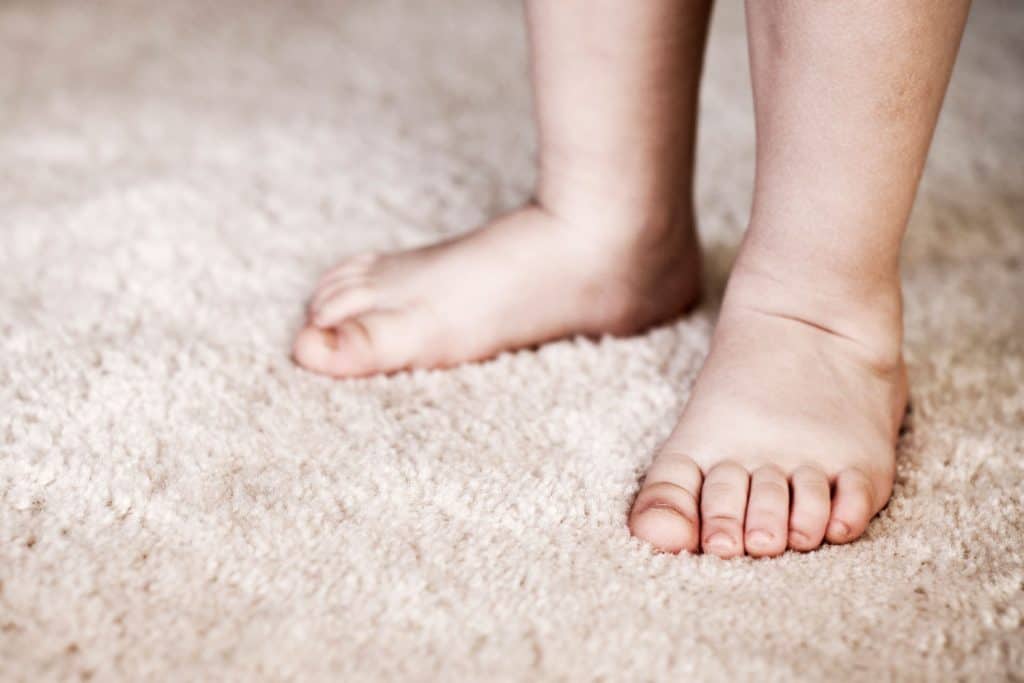 A baby walking on the carpet
