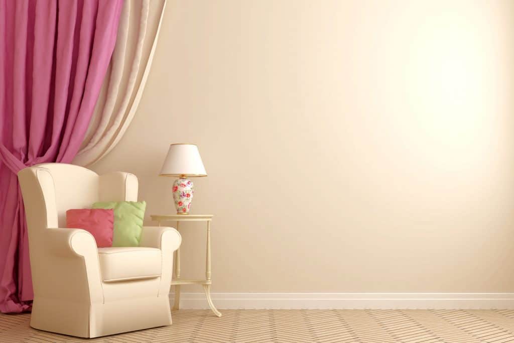 A beige wall matching pink and beige curtain