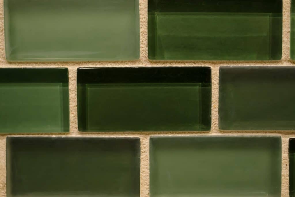 A dark green decorative tile for backsplash or background