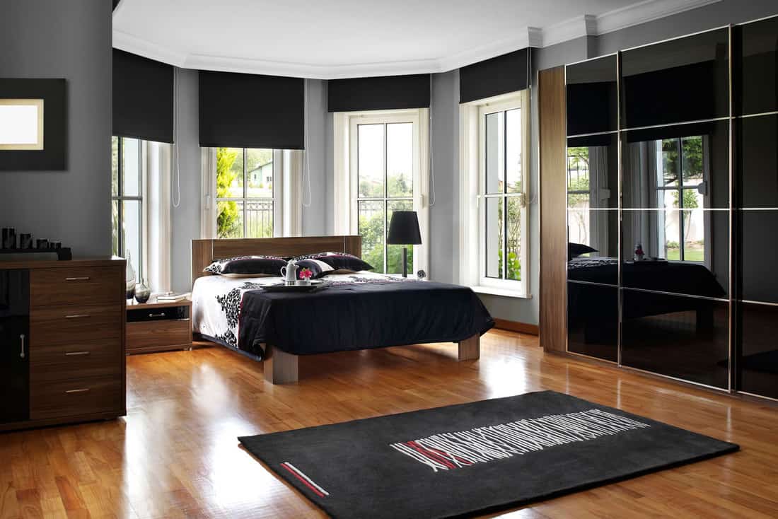A photo of a black bedroom theme with black roller blinds