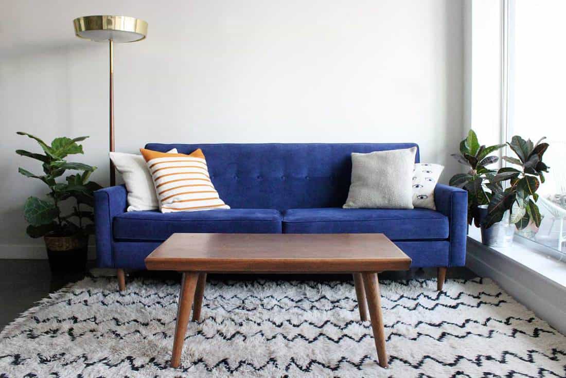 A royal blue suede mid century modern 4 seater sofa and teak coffee table