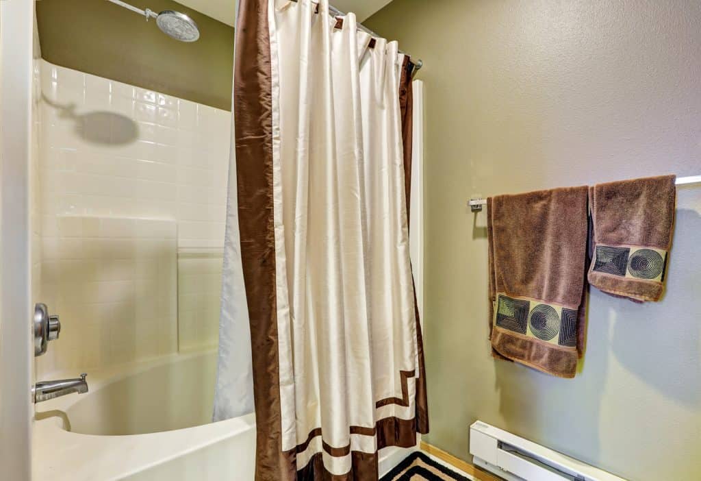 Bathroom detail. Tub and shower combo with a curtain