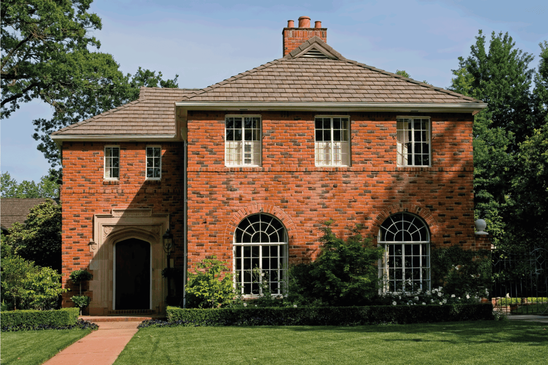 Beautiful old brick house with red pavement in front