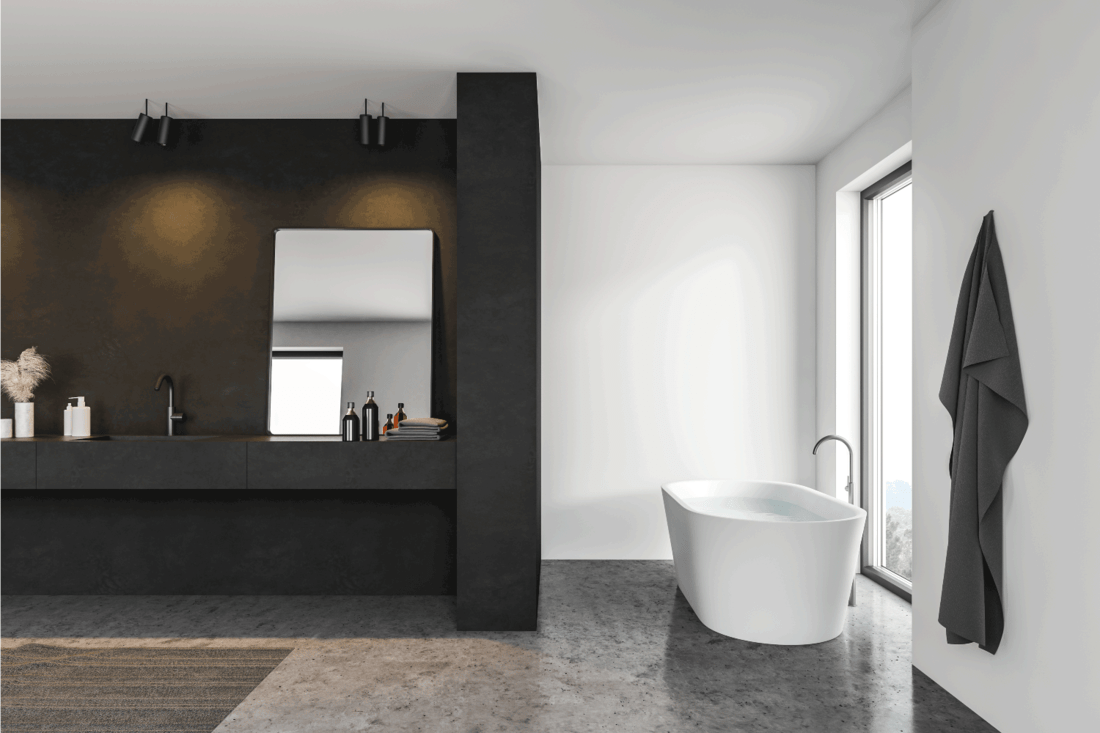 Black and white bathroom interior with gray floor, black vanity