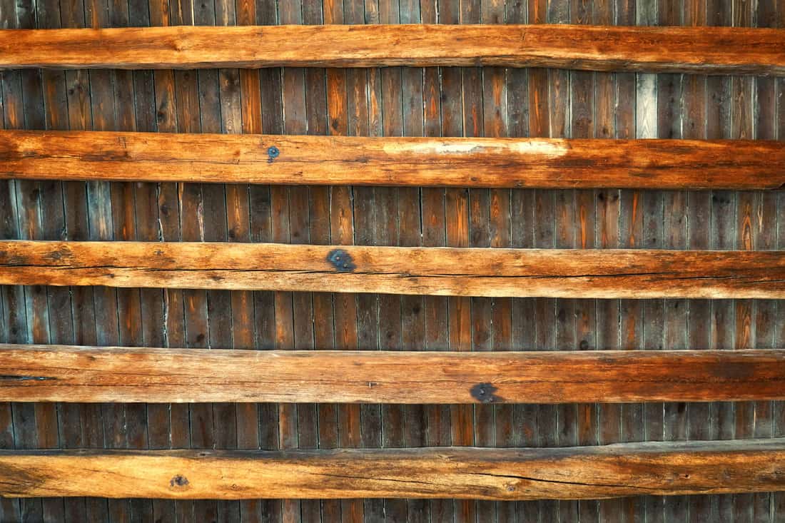 Ceiling made of old wooden beams as a background. 