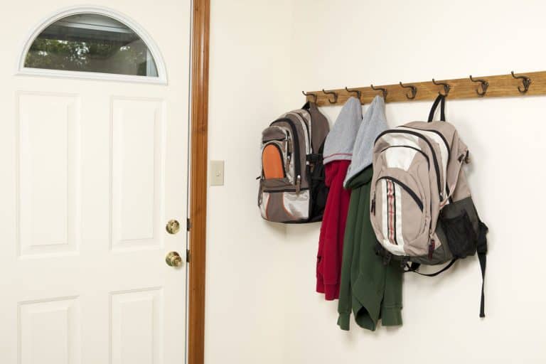 Children's bags and jackets hanged on the entryway hooks, How High To Hang Entryway Hooks