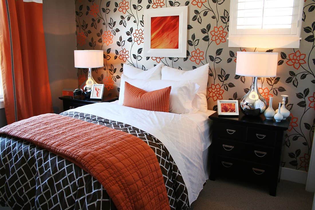 Cozy bedroom with orange flower wallpaper