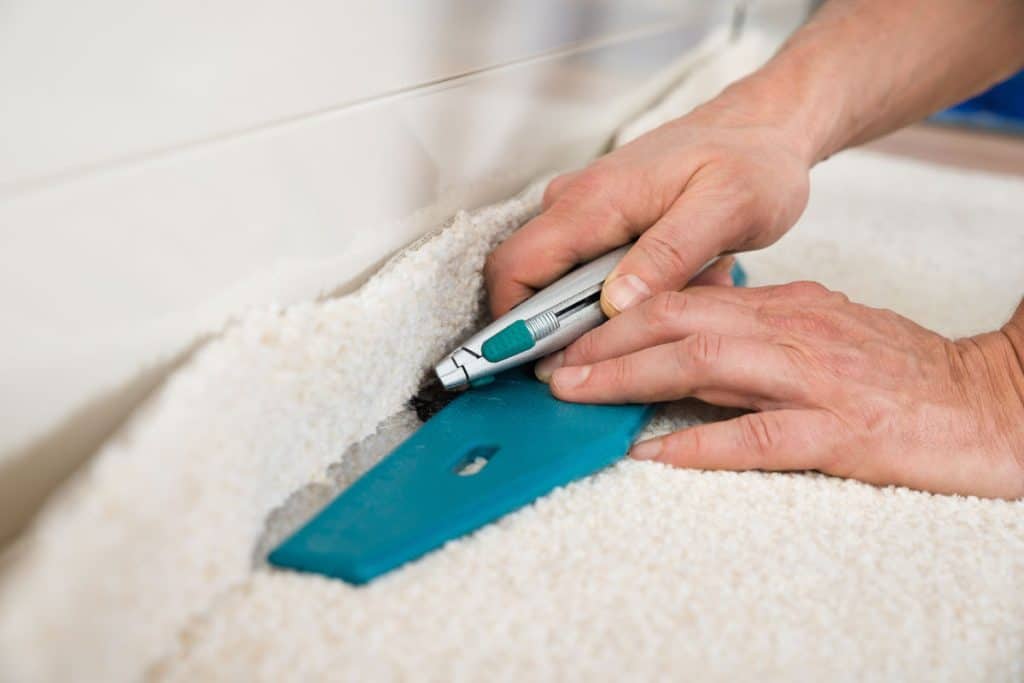 Cutting excess carpet in the installation process