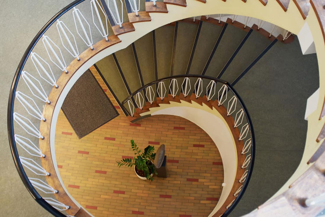 Downside view of a spiral staircase classical desgin architecture element, Where Does A Rug Runner Go? [7 Excellent Ideas To Try!]