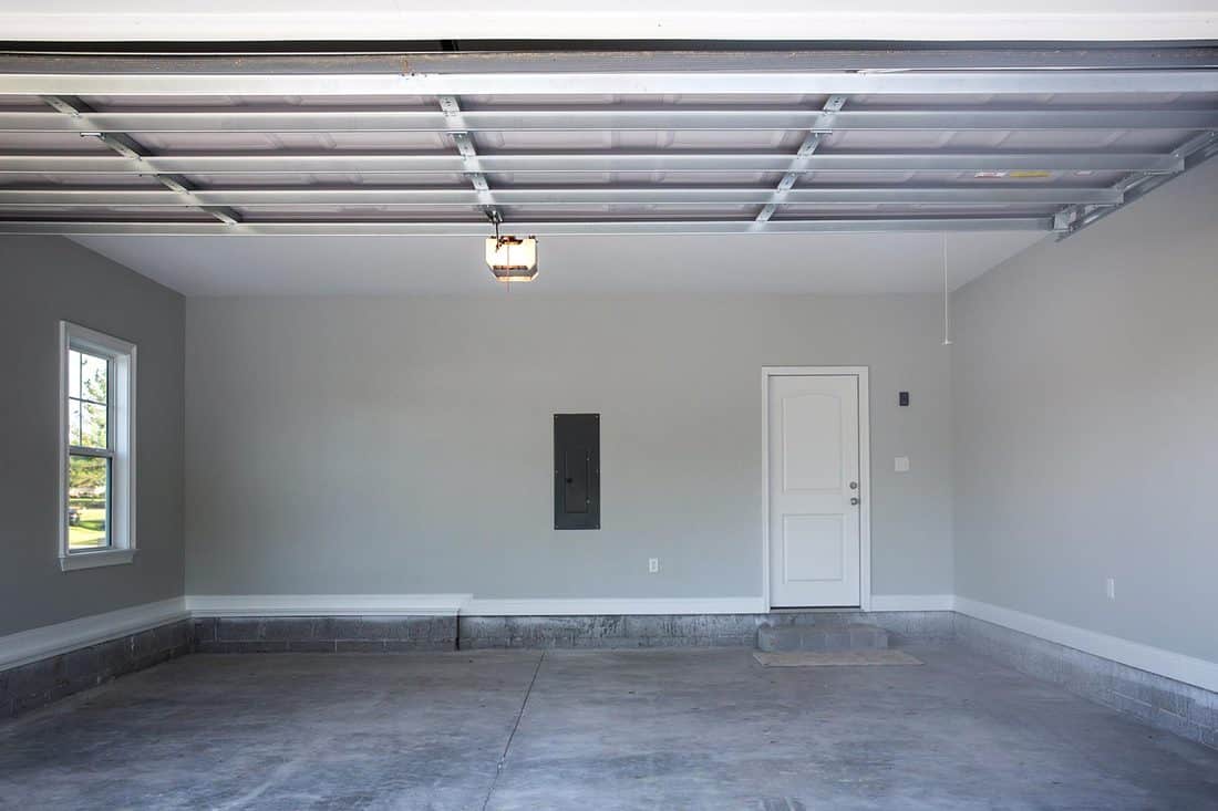 Empty large two-car garage with cement floors