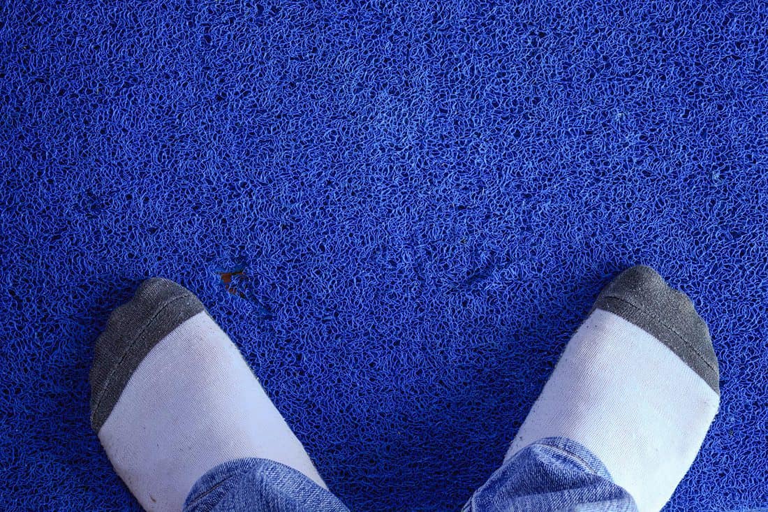 Foot on blue carpet