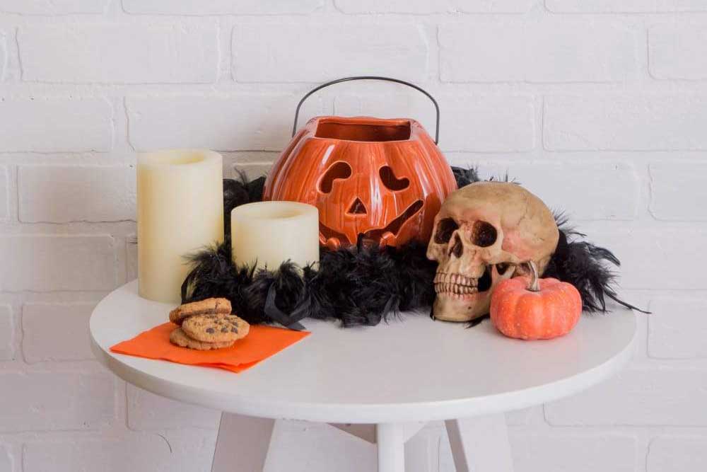 Halloween decoration on top of a round side table, 13 Spooky And Spectacular Halloween Decorations For Your Front Porch