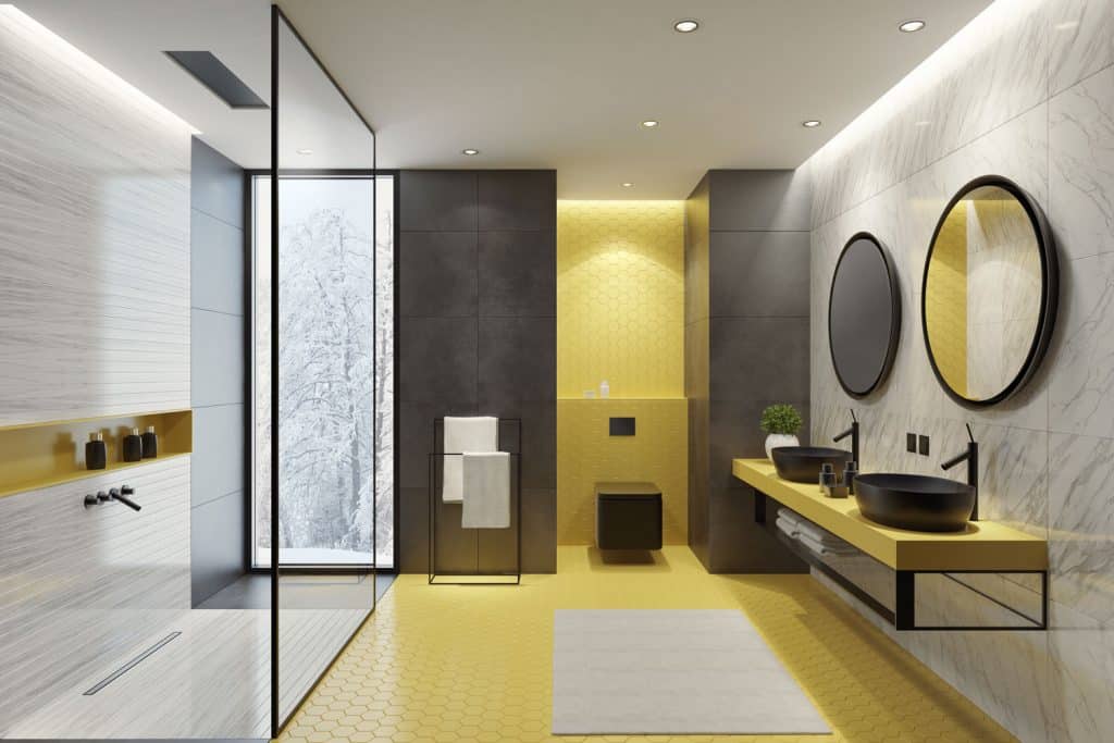 Interior of an ultra modern bathroom with a minimalist design incorporated with glass walls and colorful tiles