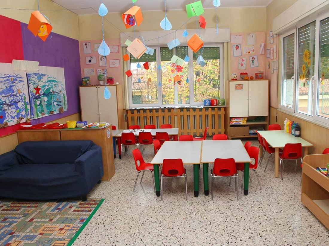 Nice classroom in a kindergarten with tables and little chairs