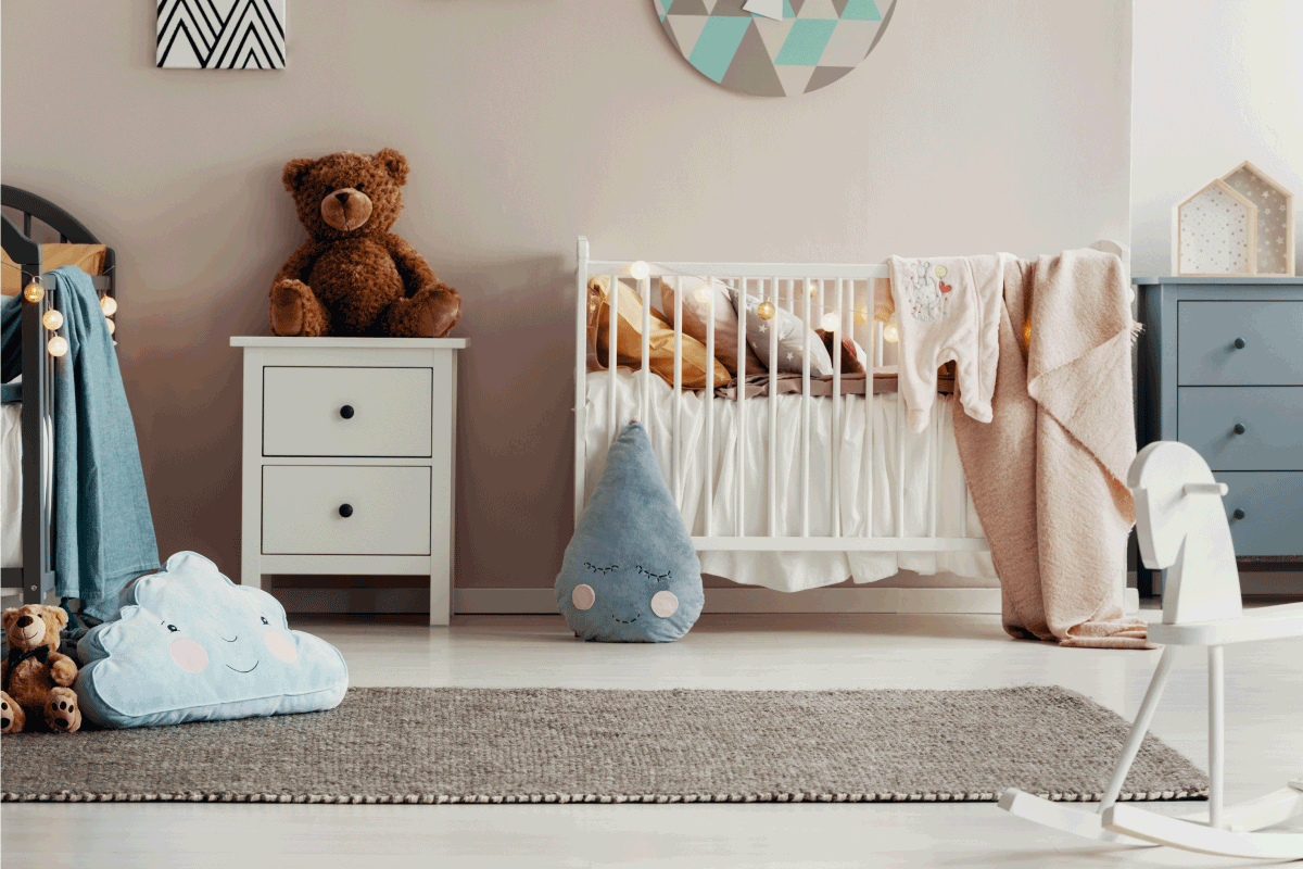 White wooden furniture in pastel scandinavian baby bedroom with rug for twins. 11 Bedroom Rug Placement Ideas To Inspire You