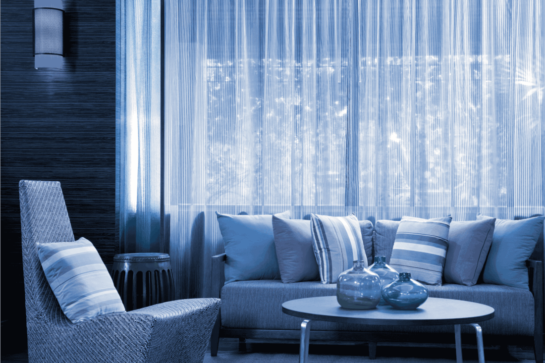 all blue living room with dreamy curtains