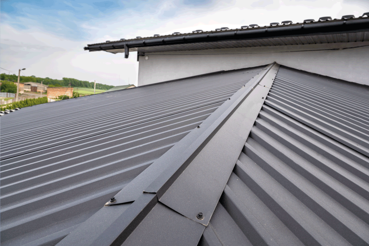 close up photo of gray colored roofing on a house. What Color Metal Roof Fades The Least