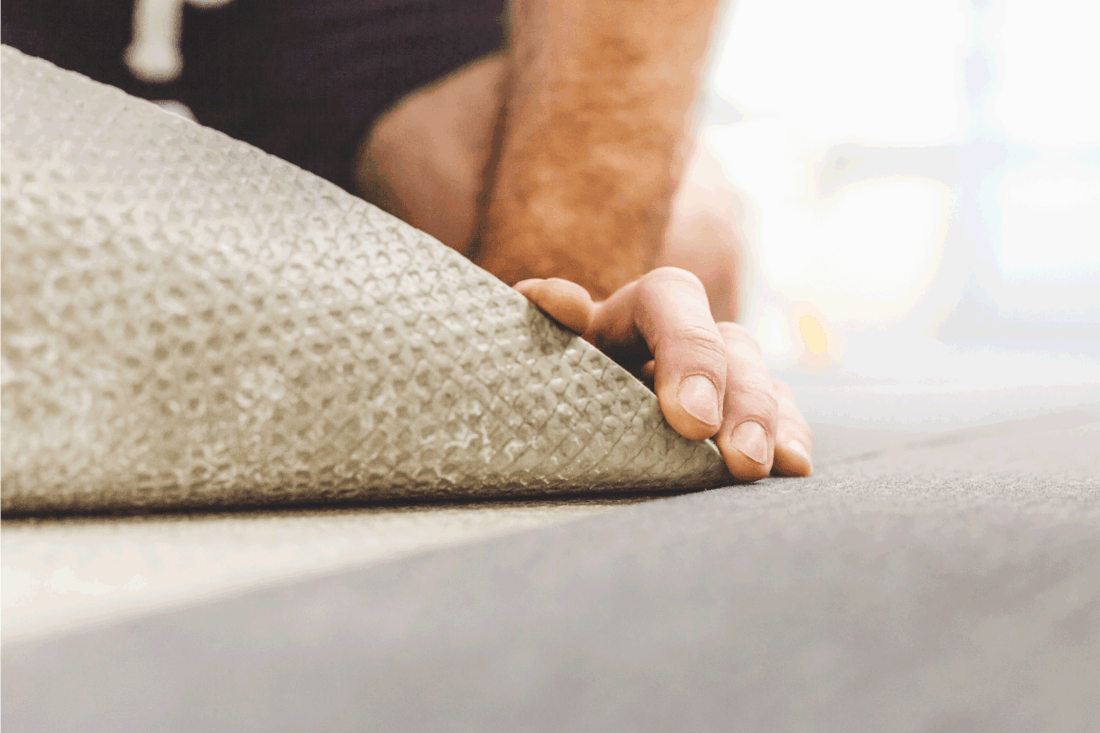 man places commercial carpet - durable wear-resistant flooring