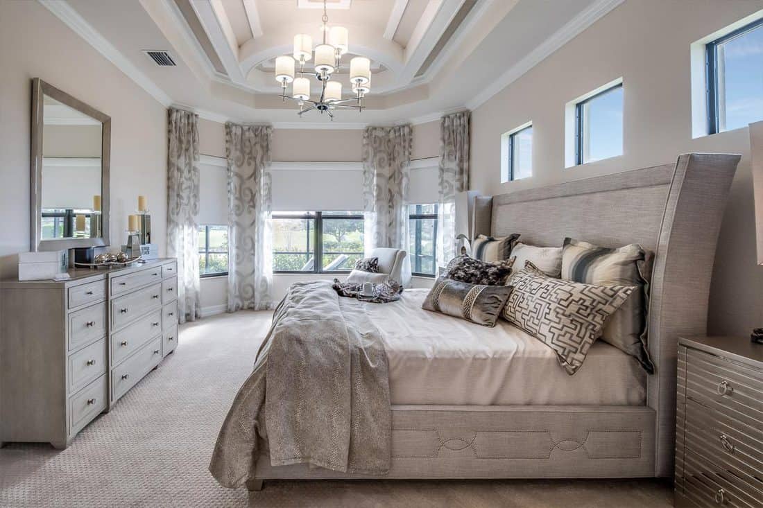 Beautiful master bedroom with gray furniture, Should The Master Bedroom Be Upstairs Or Downstairs?