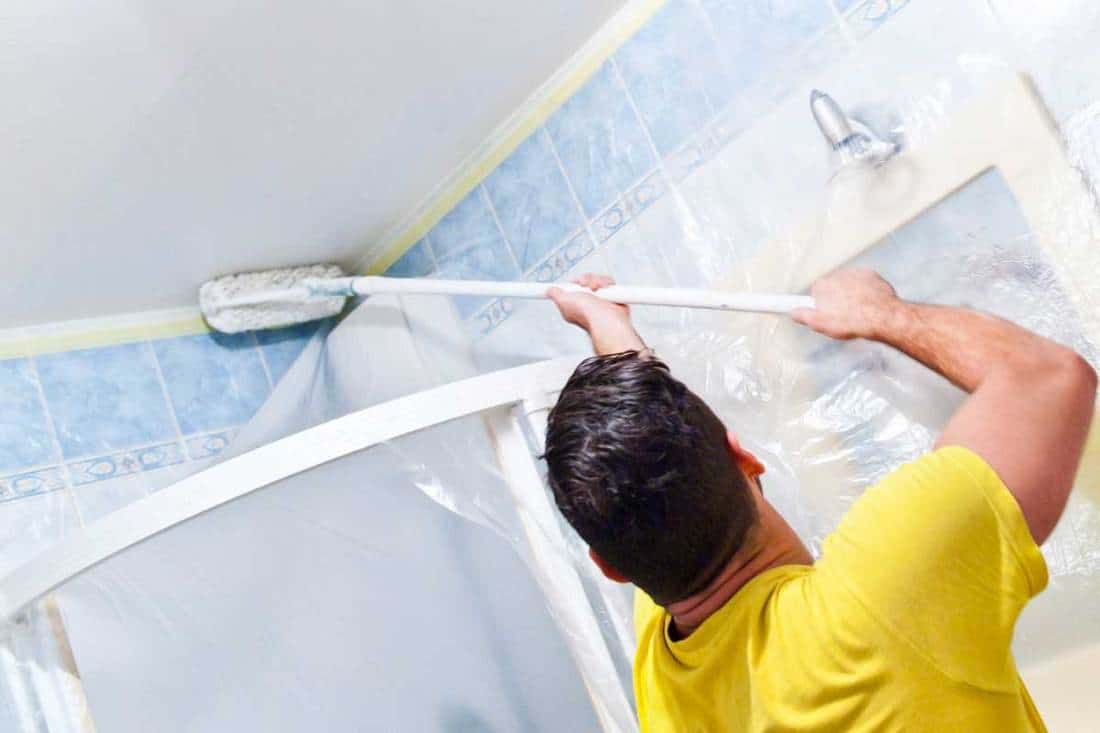 House painter painting the inside of a house bathroom, How To Paint A Bathroom Ceiling