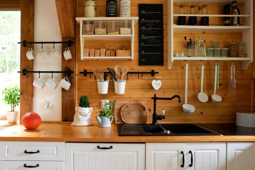 Interior of a rustic kitchen with wooden cladding