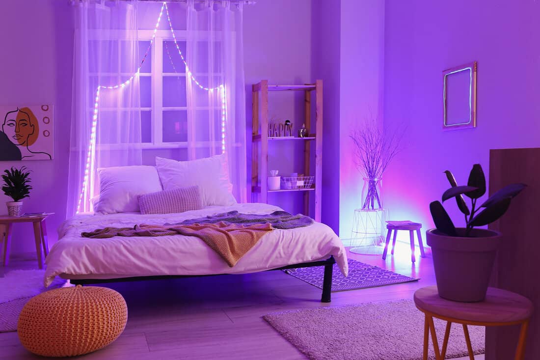 Interior of stylish bedroom with neon lighting