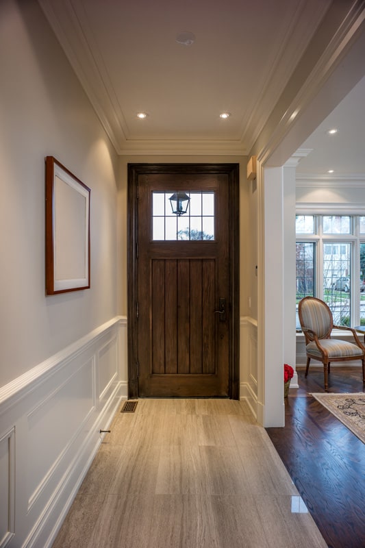 Rustic inspired with white walls, laminated flooring and a wooden front door