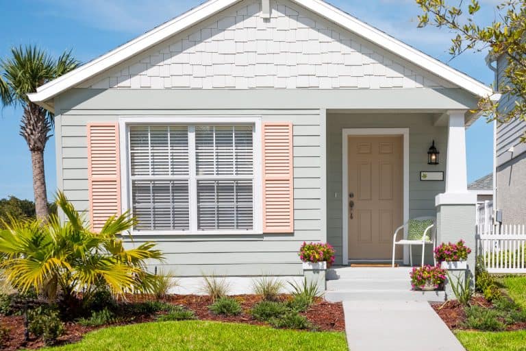 Small cottage with shutters, flowers, front yard and sidewalk, What Color Siding Goes With White Brick?