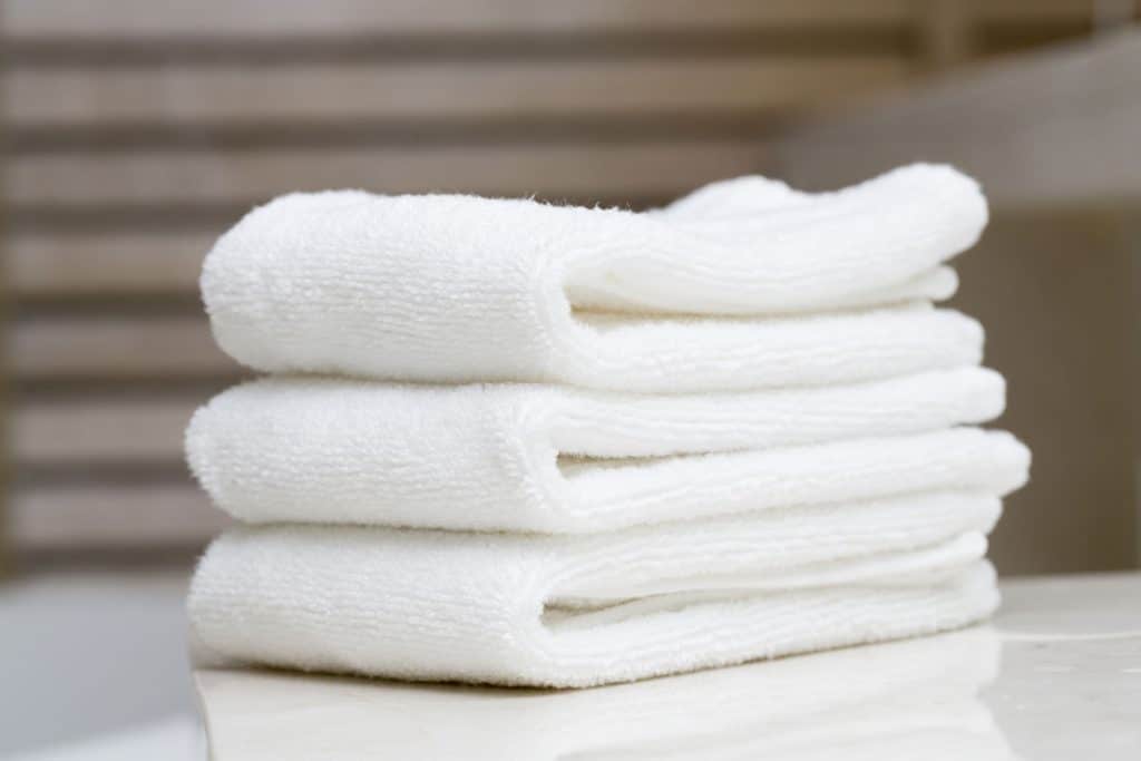 White folded towels placed on a table at the hotel