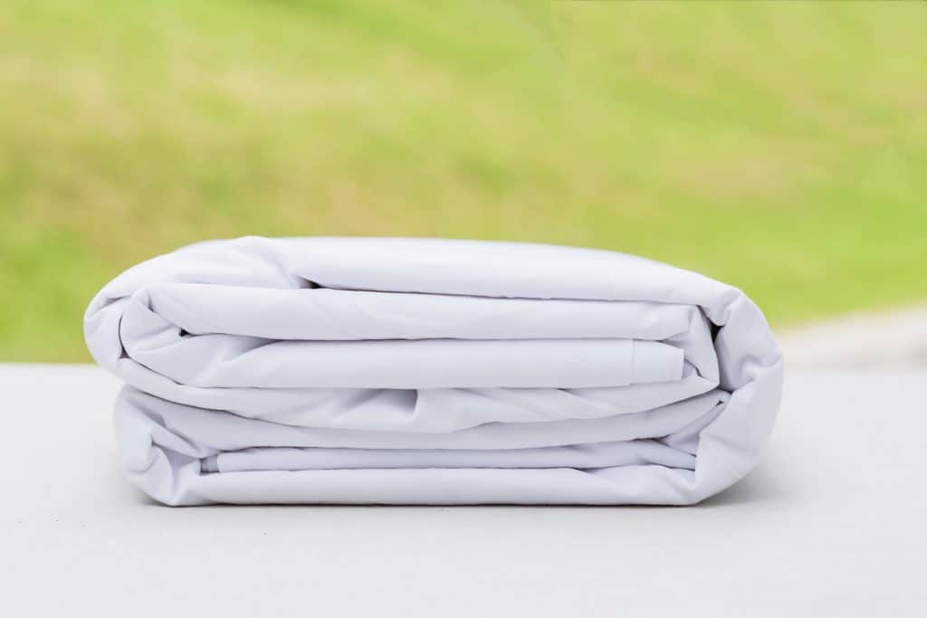 A white folded fitted bed sheets