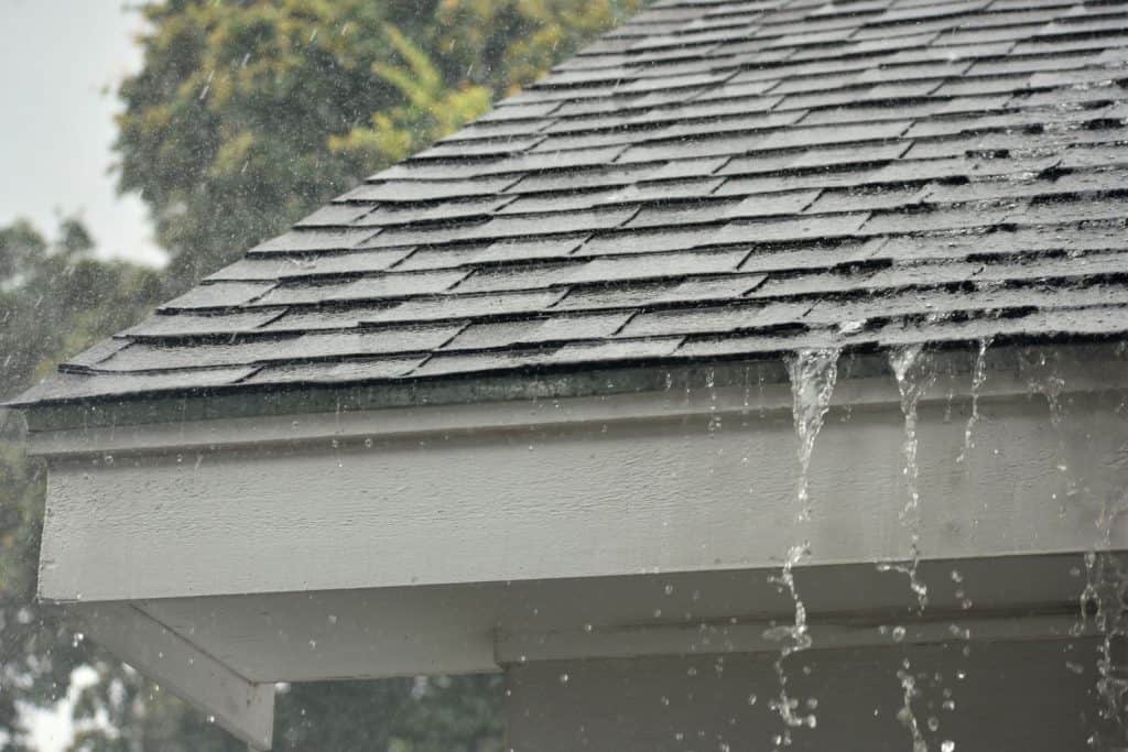 Heavy downpour on the shingle roofing of a house
