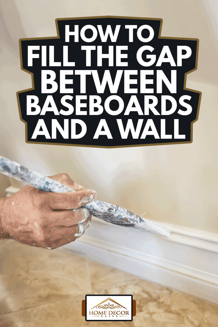 A painter puts the finishing touches on the painting of a baseboard molding, How To Fill The Gap Between Baseboards And A Wall