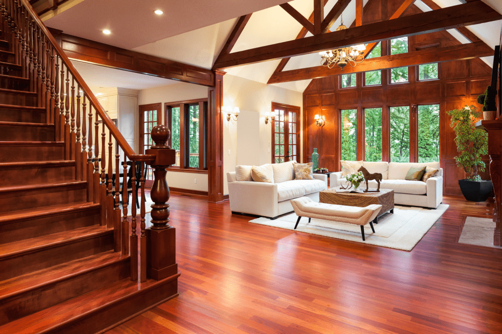 Interior of a rustic inspired living room with hardwood flooring, hardwood stairs and an elegant entertainment area