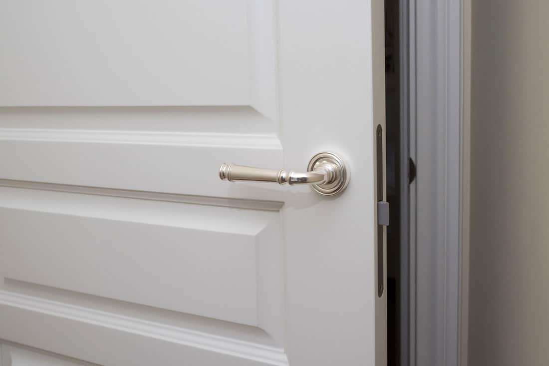 White door with the silver handle, Should Door Handles And Knobs Match Throughout The House?