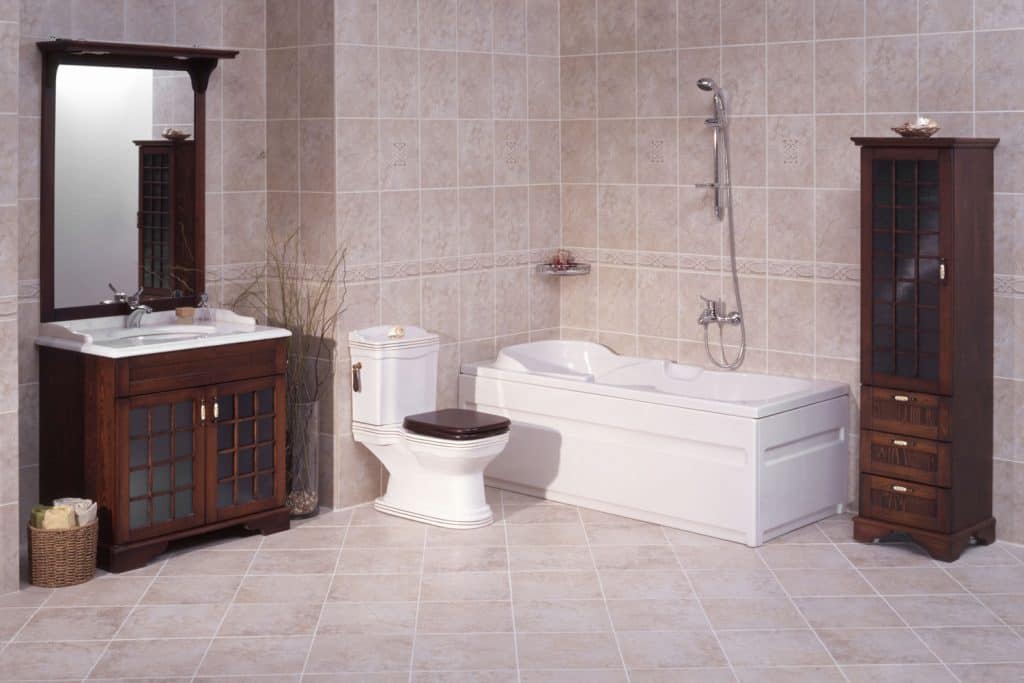 A spacious and classic themed bathroom with a white fitted bathtub