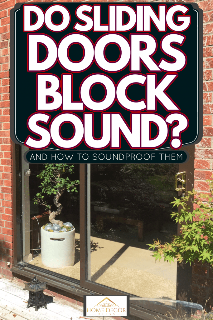 A glass sliding door of a two story house leading to the garden, Do Sliding Doors Block Sound? [And How To Soundproof Them]