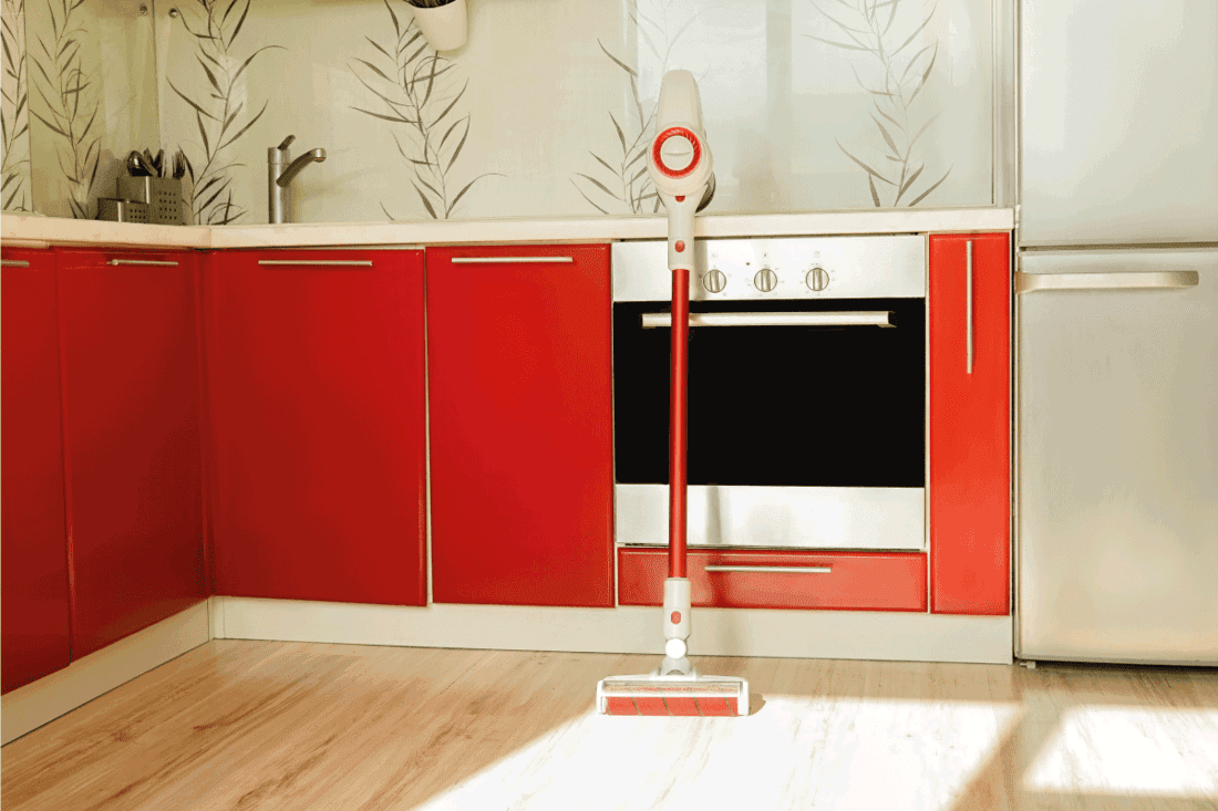 Red wireless vacuum cleaner. Red kitchen and sunshine in floor. How To Unclog A Blocked Dyson Cordless Vacuum