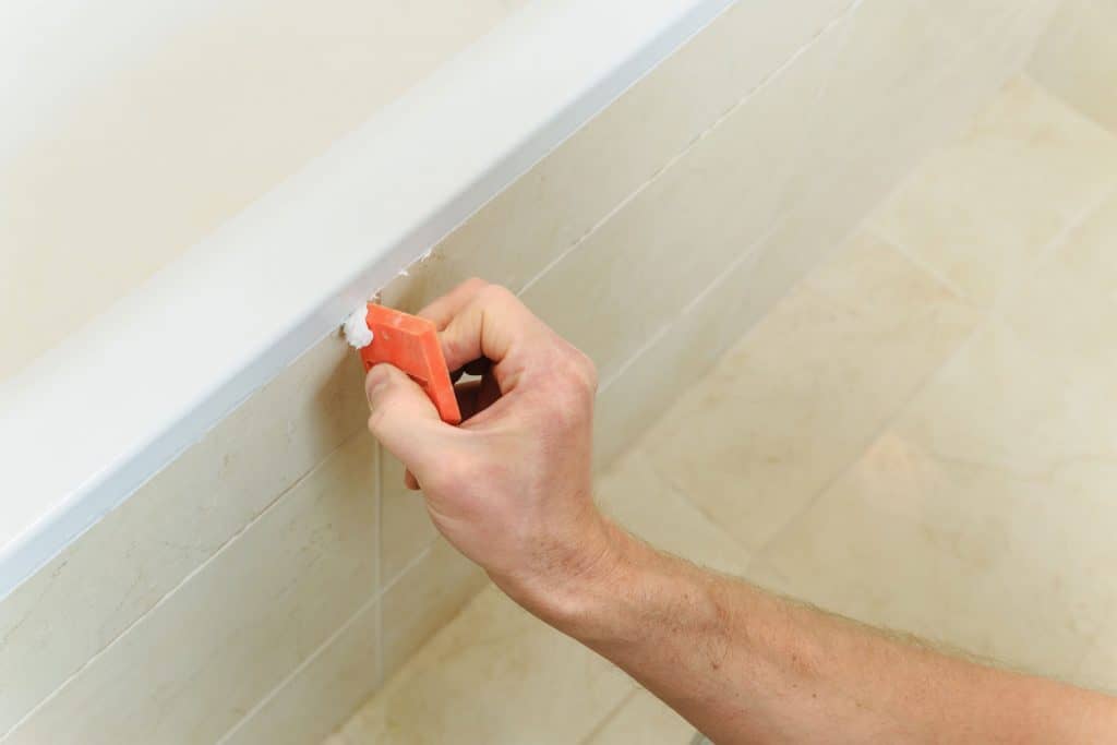 Smoothing out silicone sealant in the bathroom