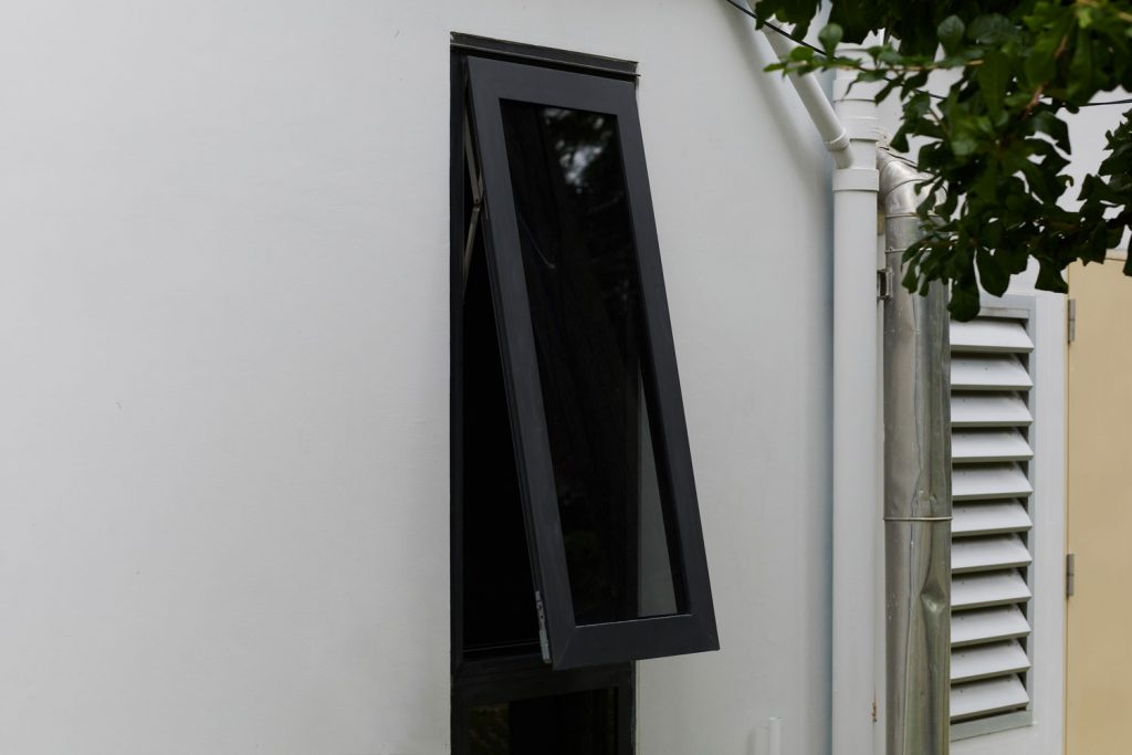 A black colored casement awning window