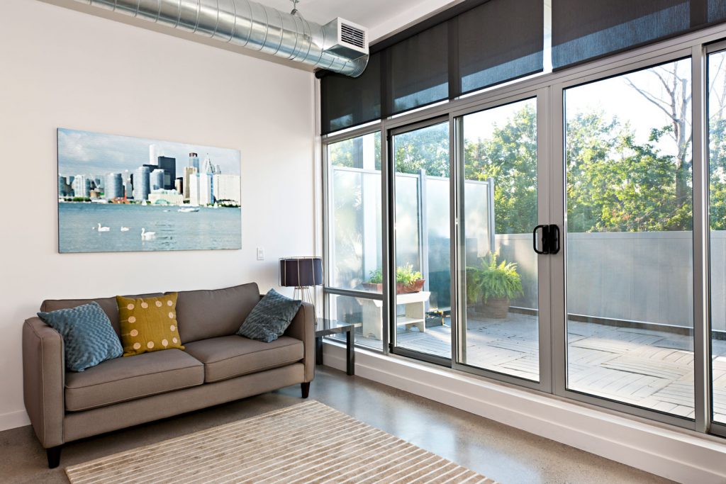 A gorgeous and elegant living room with modern designed and a huge sliding door on the side leading to the garden area