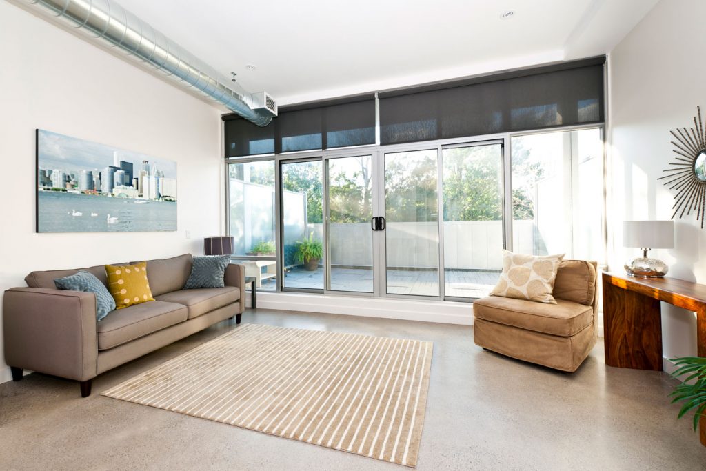 A huge contemporary living room with carpeted flooring