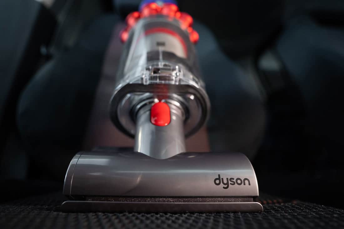 A selective focus photo of a Dyson cordless vacuum, How Long Do Dyson Cordless Vacuum Battery Last [And How To Replace It]