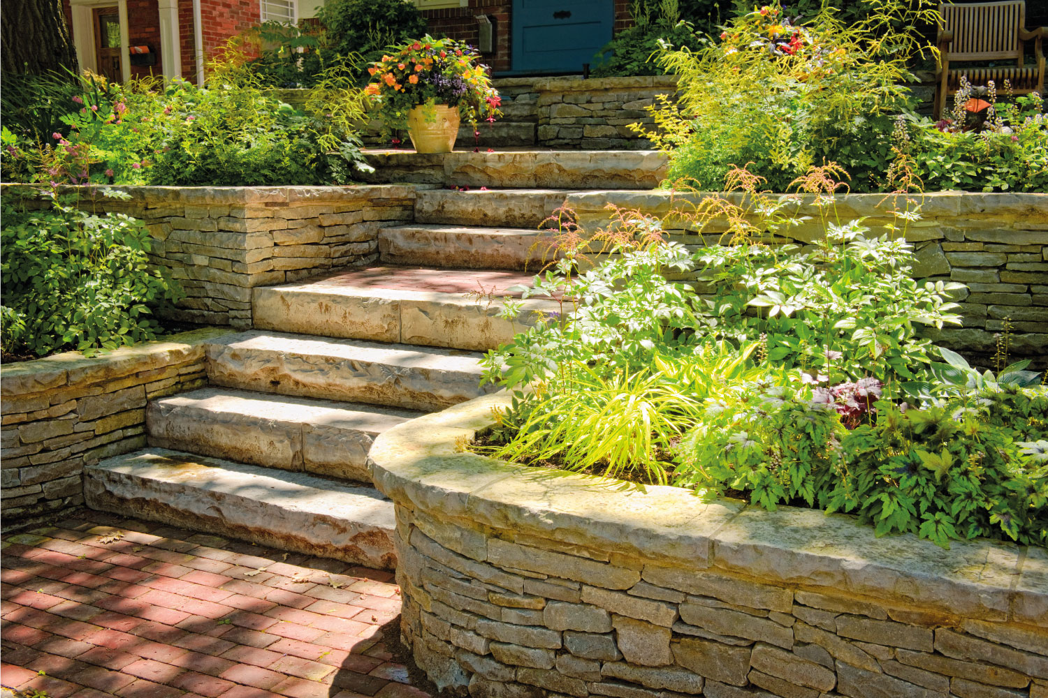 Natural stone landscaping in home garden with stairs, natural stone retaining wall