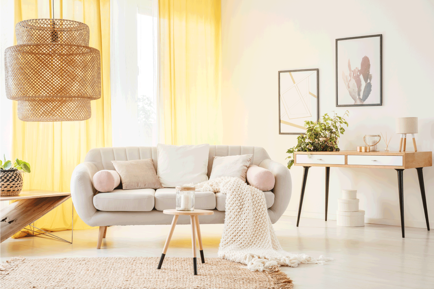 Rattan lamp and wooden stool on carpet in warm bohemian living room with yellow curtains and beige settee with white pillows