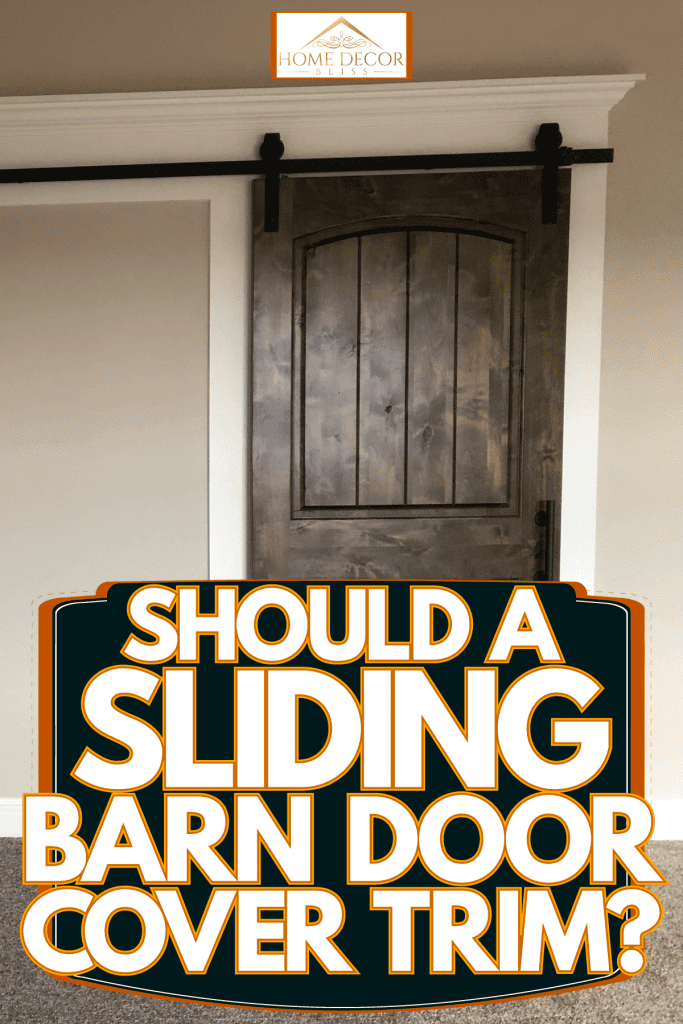 A small barn door made form hardwood planks, Should A Sliding Barn Door Cover Trim?