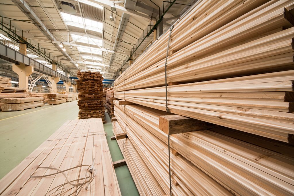 Stockpiles of wooden sidings inside a huge factory