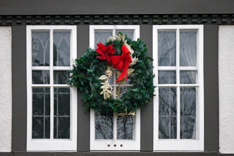 White casement windows with a Christmas wreath hanged on the middle, How To Clean A Casement Window